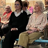 720019224_1297871785833978_5046833855670787546_n Front row of older adults seated and watching a presentation at a community event.