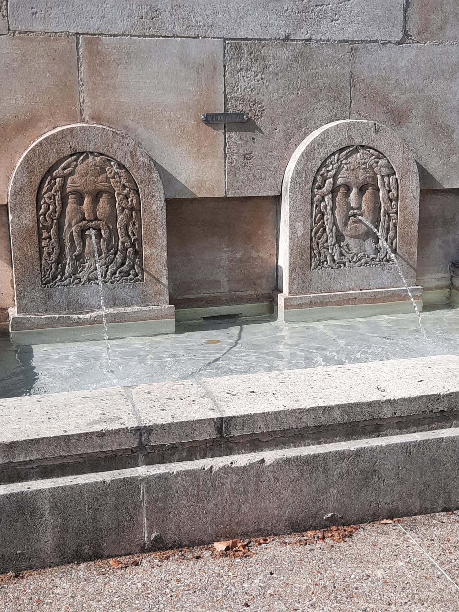 731045144_1308620188092471_5066955904636694044_n Two carved stone fountains set into a wall, each with arched frames and water spouting from the mouths.
